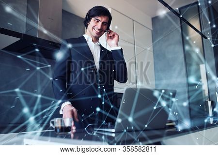 Businessman Works From Remote At House With A Laptop Due To Coronavirus Quarantine.