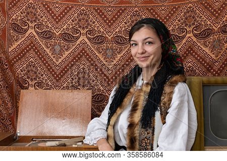 Waist Up Photo Of A Happy Woman In Natioanal Clothes Who Is Sitting Near The Old Retro Tv And Vinyl 