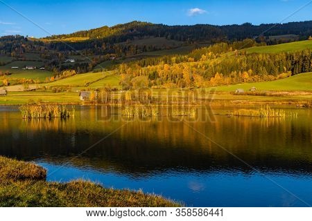 autumn pond under the mountains, Murau district,
Styria, Austria