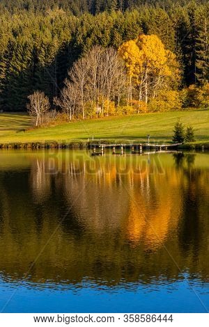 autumn pond under the mountains, Murau district,
Styria, Austria