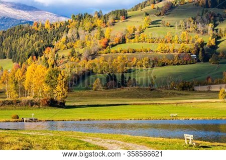 autumn pond under the mountains, Murau district,
Styria, Austria