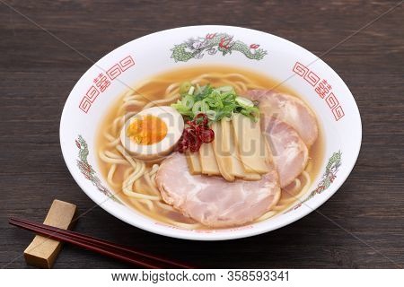Japanese Miso Soup Ramen Noodles In A Bowl With Chopsticks On Table