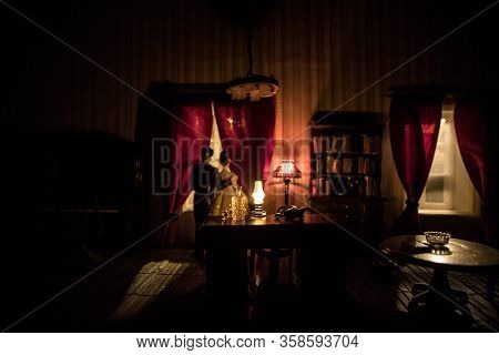 A Realistic Dollhouse Living Room With Furniture And Window At Night. Artwork Table Decoration With