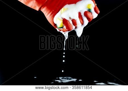 Scouring Sponge Foaming Gloves And Yellow Cleaning Cloth. In Black Background. Clse Up.