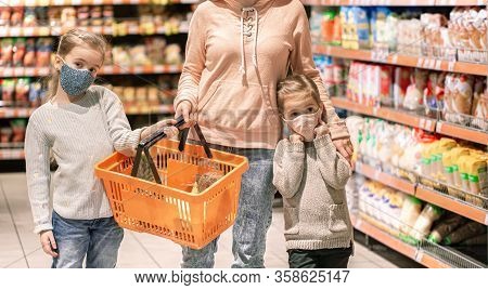 Mom And Kids Are Shopping At The Grocery Store. They Wear Masks During Quarantine. Coronavirus Pande