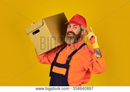 Its Always Saturday. Unpacking Moving Boxes. New House At Moving Day. Man Builder In Boilersuit Hold