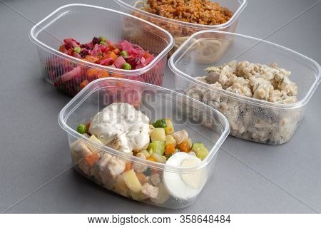 In The Foreground Is Olivier Salad. Pasta With Minced Meat And Onion In Navy-style And A Jar Of Vina