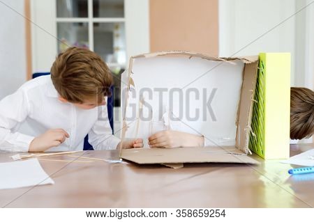 Two Little School Kids Boy Making Paper Doll Theatre. Happy Children And Friends Creating Figures An
