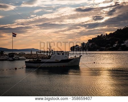 Sunset Over The Mediterranean Sea In Drvenik Harbor With Boats, Croatia