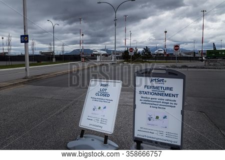 Richmond, Bc, Canada - Mar 29, 2020: A Closed Sign At A Parking Lot At Yvr With An Aircraft Parked I