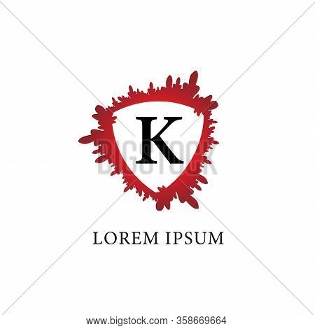 Letter K Alphabet Logo Design Template. Splash Of Blood With Shield Shape In The Midle. Isolated On 