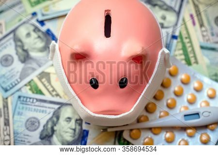 Piggy Bank In A Mask On A Background Of American Currency.the Concept Of Coronavrius Epidemic