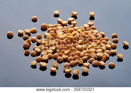 A Large Amount Of Pea Groats Poured Onto A Black Reflective Surface, Macro Photography, Legumes. Fab