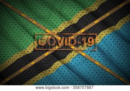 Tanzania Flag And Covid-19 Stamp With Orange Quarantine Border Tape Cross. Coronavirus Or 2019-ncov 