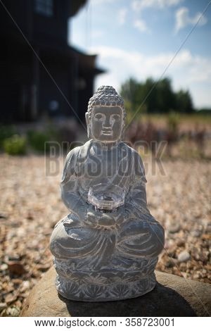 Large Grey Buddha Statue On The Street.