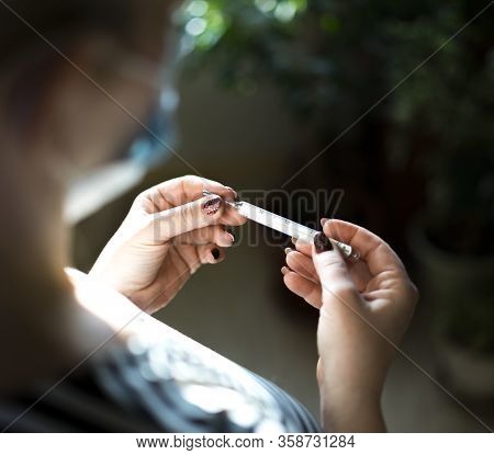 A Girl Holds Thermometer. Stay At Home. Stay Safe. Shallow Depth Of Field.