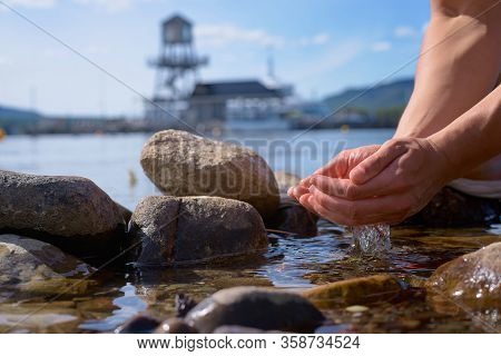 Male Hands Pick Up Clean Water From Memphremagog Lake, Province Of Quebec, Canada