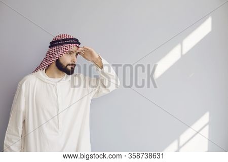Attractive Smiling Arab Man Looking On A Gray Background