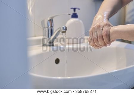 Unrecognizable Female Shows How To Wash Hands Properly. Woman Washs Hands With Soap. Scrubbing Hands