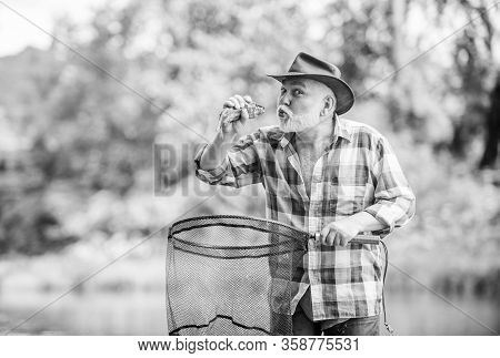 Fishing Lover. Mature Man Fishing. Retired Bearded Fisher. Big Game Fishing. Sport Activity And Hobb