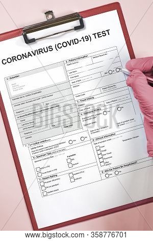Hands Of Unrecognizable Doctor Or Nurse Filling Coronavirus Test Form. Get Covid-19 Test. Testing Fo