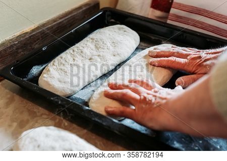 Female Hands Putting Raw Homemade Bread Loafs On The Oven Tinplate. Homemade Cooking