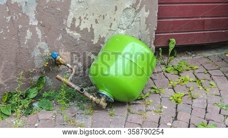 Green Propane Bottle Lying Improper On The Street