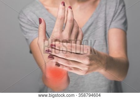 Elderly Woman Suffering From Pain, Weakness And Tingling In Wrist. Causes Of Hurt Include Osteoarthr