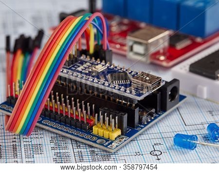 Arduino And Programmers With Peripherals And Expansion Boards Lie On A Gray Background. Do It Yourse