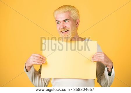 Portrait Of Man Showing Blank Signboard With Copyspace Area For Slogan Or Text. Blank, Empty Paper, 