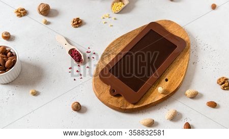 Homemade Chocolate In Mold. Chocolate Bar, Nuts, Freeze Dried Fruits On White Background Top View. C