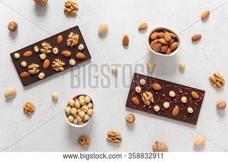 Dark Chocolate Bars With Nuts On White Background. Homemade Organic Chocolate. Top View, Flat Lay