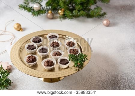 Homemade Dark And Milk Chocolate Pralines Candies On Golden Stand. Side View. Christmas Candies. Cho
