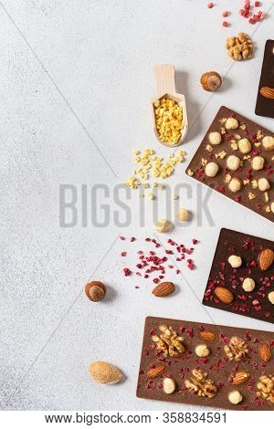 Homemade Dark And Milk Chocolate Bars With Dried Berries And Nuts On White Background. Chocolate Mad