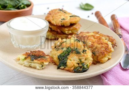 Pancakes With Cabbage And Spinach. Juicy Vegetable Cutlets On A Plate With Sour Cream. Diet Menu. Le