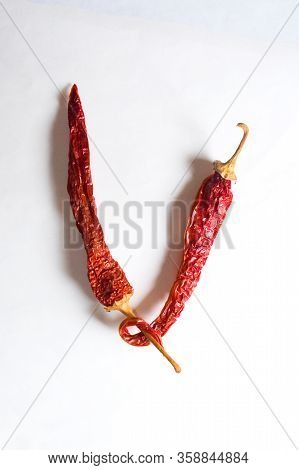 Letter V Lined With Red Peppers On A White Background. Symbol In The Form Of The Letter V. Pepper Li