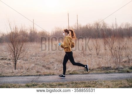 Covid-19 Pandemic Coronavirus Girl In Mask And Blue Gloves During Quarantine Went Out To Run