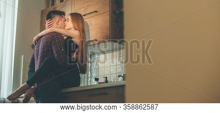 Caucasian Girl With Red Hair And Freckles Is Ebracing Her Lover In The Kitchen