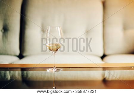Glass With White Wine With Blurry Background, Quiet Evening Of A Hard Day