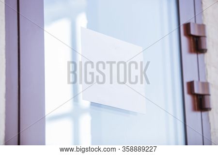 Coronavirus Pandemic. A Disinfector In A Protective Suit Leaves Warning Sign On The Door, Copyspace.