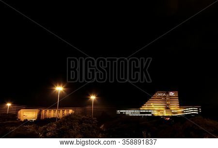 Night Time View Of Unisa Main Building With Lights On
