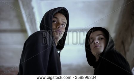 Two Boys Looking Back, Afraid To Be Caught For Committing Crime, Circumspect