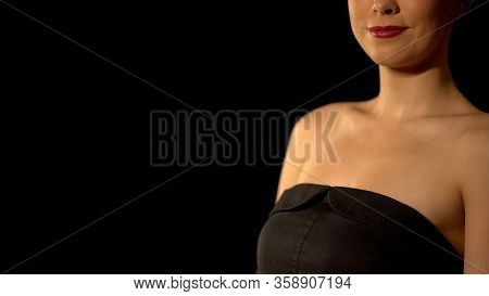 Elegant Woman In Black Dress Standing Against Black Background, Beauty Concept