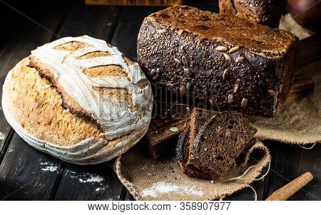 Assortment Of Baked Goods On Wood Background. Rye Bread. Wheat Bread. Vegeterain Food Concept. Sourd