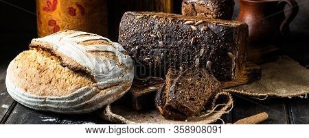 Assortment Of Baked Goods On Wood Background. Rye Bread. Wheat Bread. Vegeterain Food Concept. Sourd