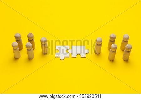 Wooden Figures With Pazzles On Yellow Background. Agreement Between Business Mans, Cooperation And D