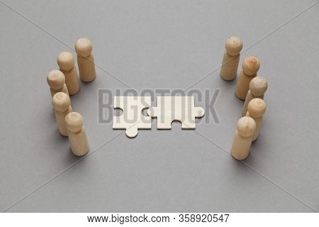 Wooden Figures With Pazzles On Grey Background. Agreement Between Business Mans, Cooperation And Dea
