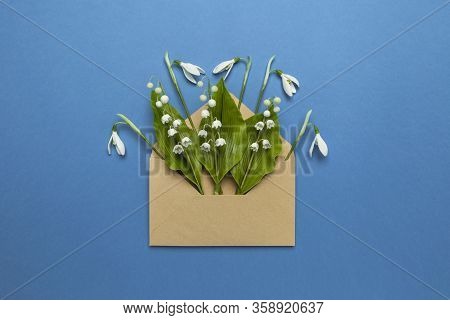 Spring Flowers In A Mail Envelope On A Blue Background. Romantic Birthday Greetings, Creative Weddin