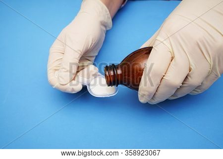 Doctor Gives An Antibiotic On A Plastic Spoon
