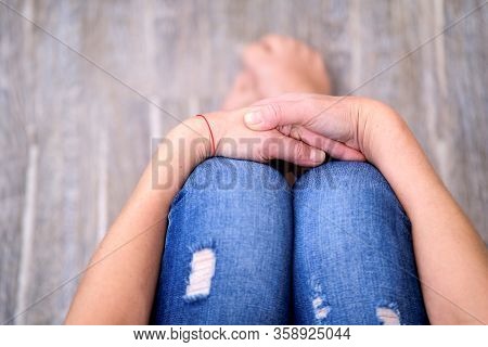 The Girl Is Sitting With Her Hands Folded In Her Lap. Forced Seclusion During The Quarantine Period.